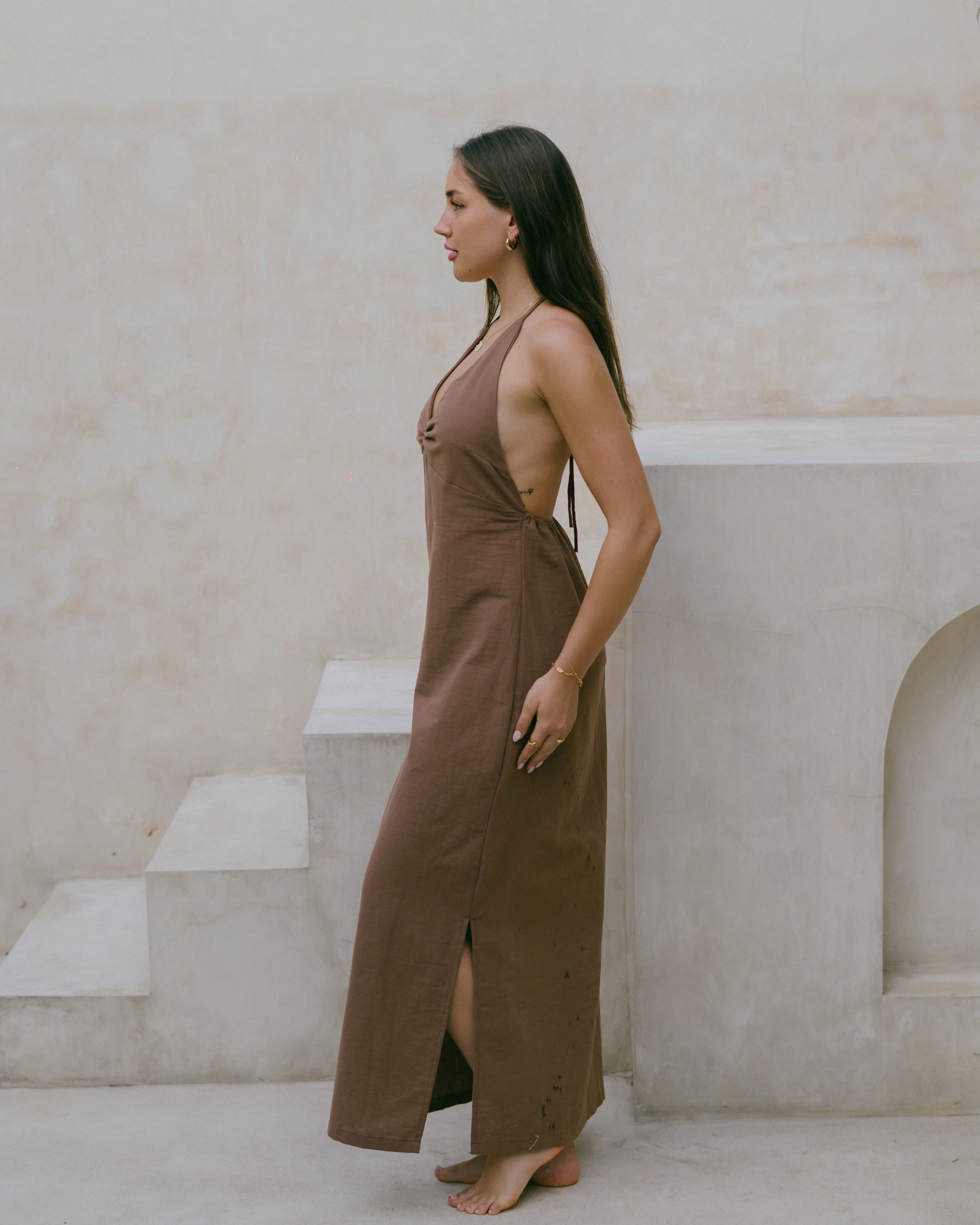 The Palma Halter Maxi Dress blends effortless elegance with comfort, featuring a ruched bust, flowing silhouette, and open-back design.