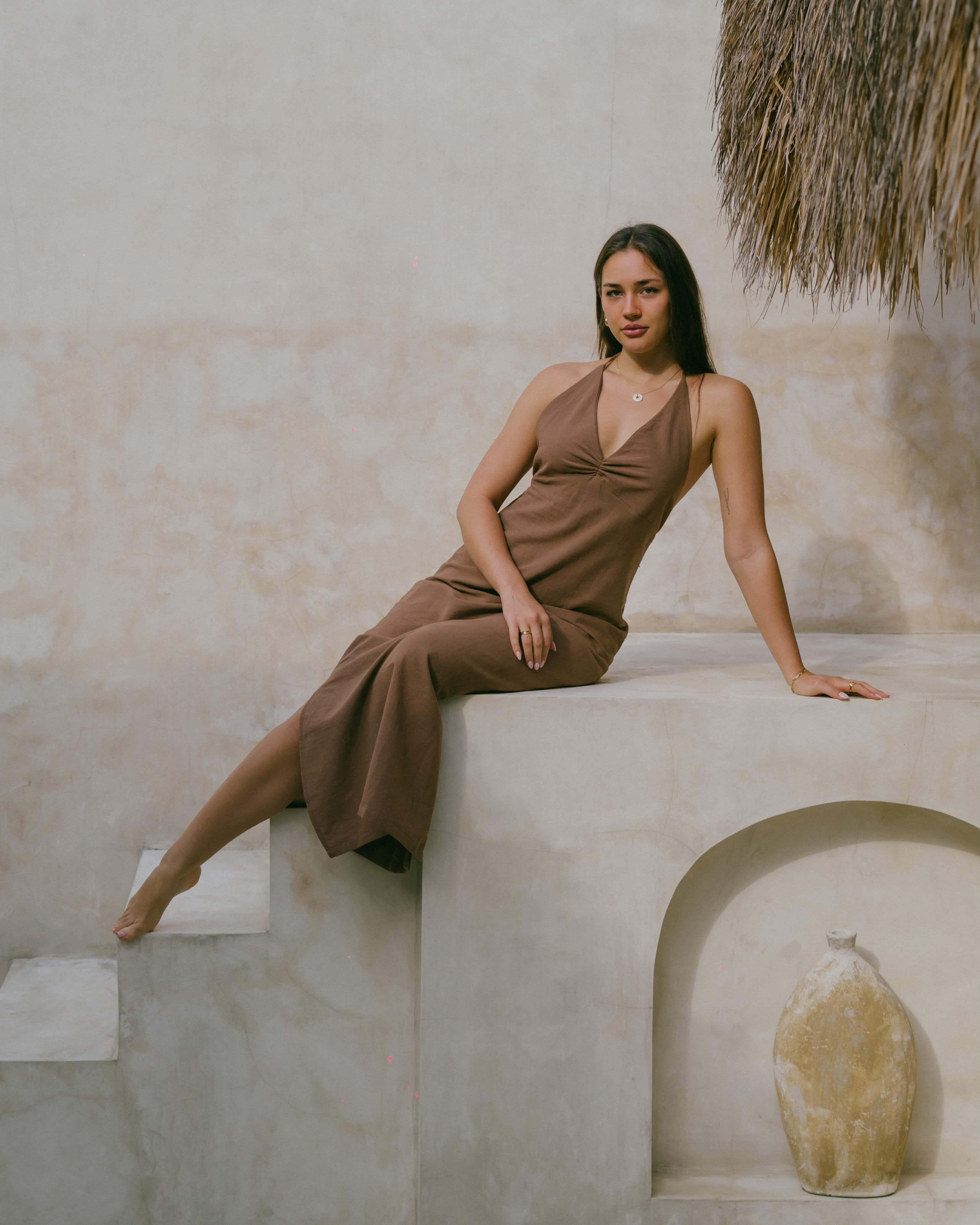 Embrace summer elegance in the Palma Halter Maxi Dress, featuring a ruched bust, halter neckline, and open back in a rich chocolate brown.