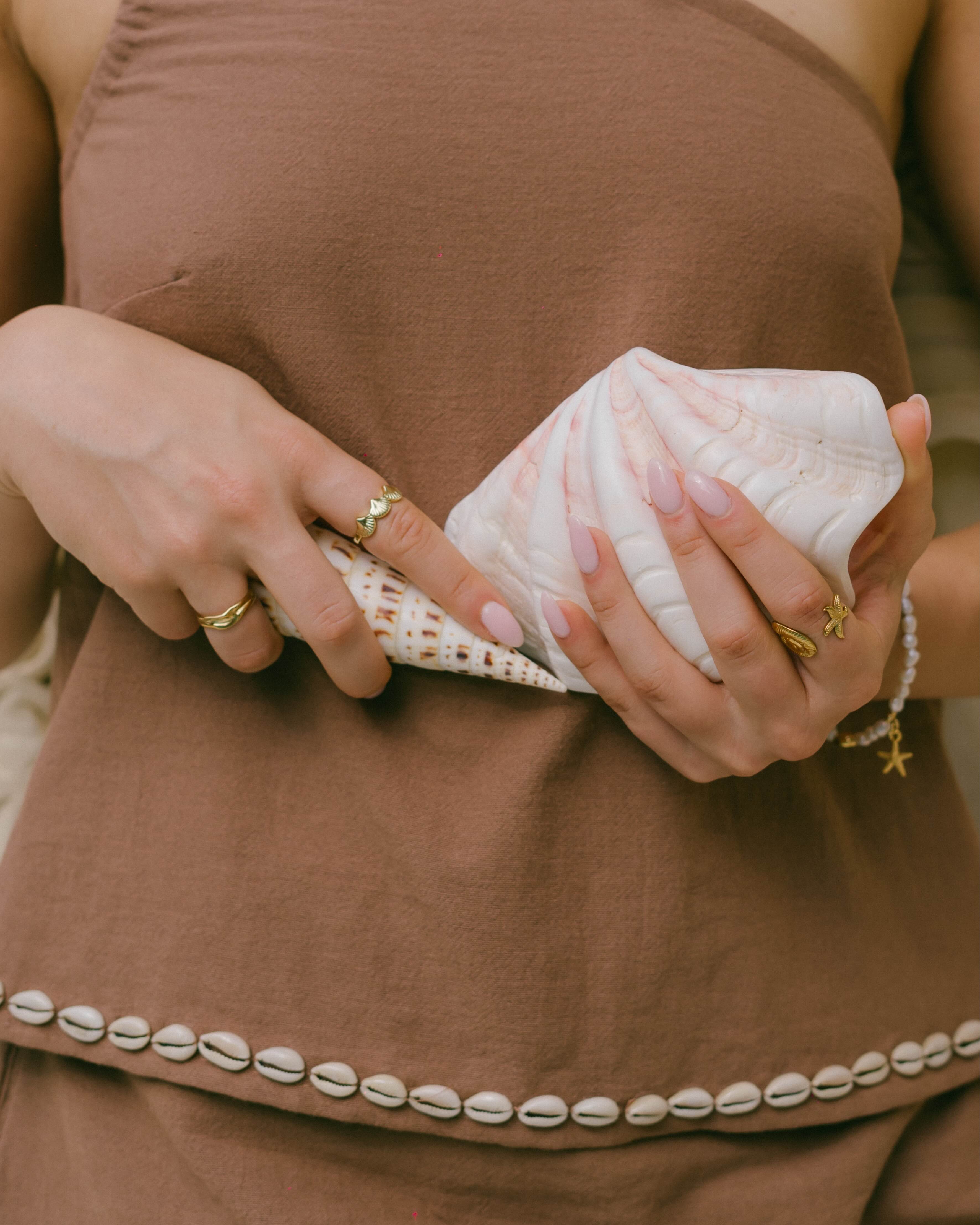 Perfect for sunset dinners or beachside escapes, the Coralie Shell Top embodies effortless summer style with its chic, ocean-inspired design.