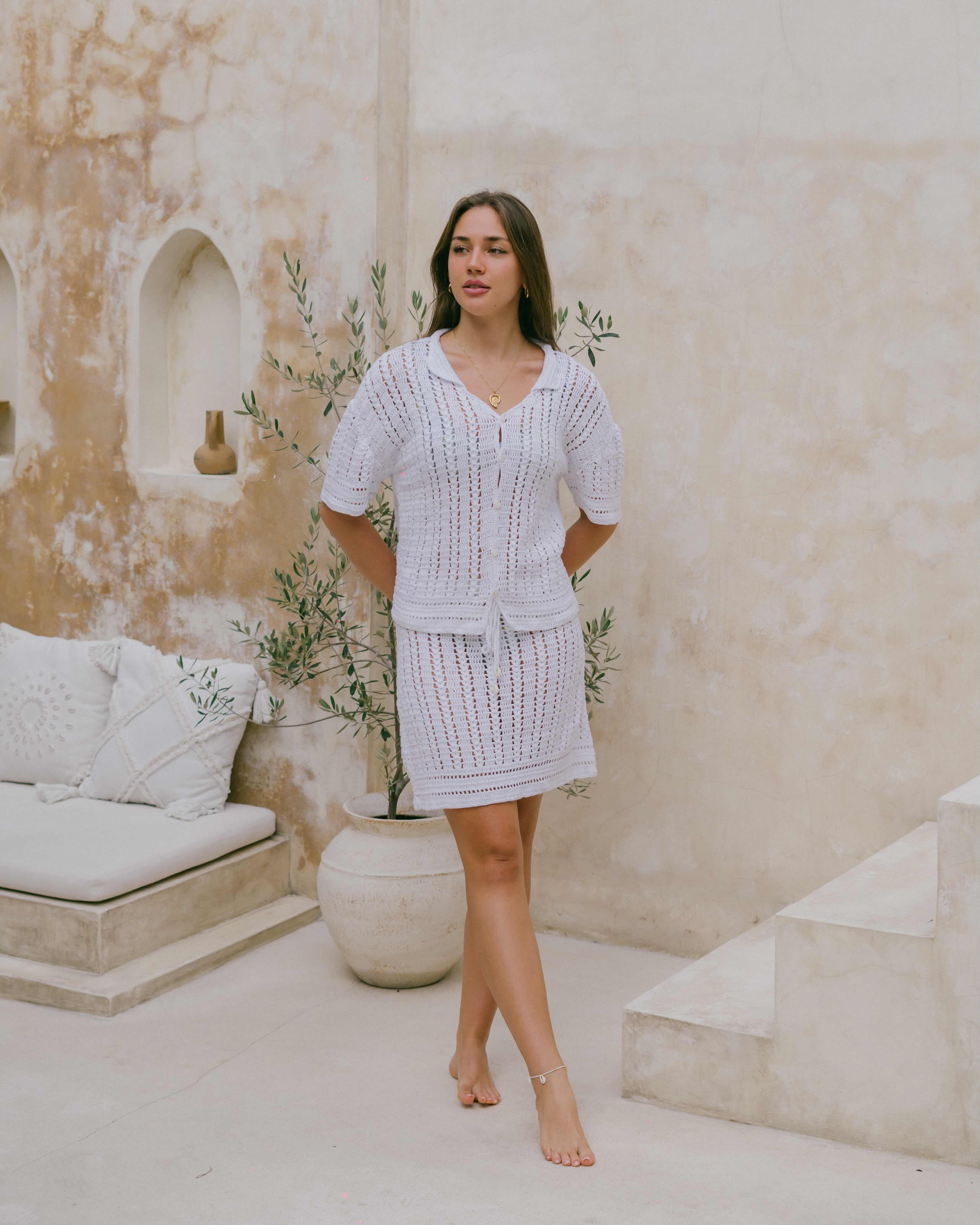 Lightweight and semi-sheer, the White Sands Crochet Skirt is a coastal-inspired piece with an adjustable tie waist and delicate shell accents.