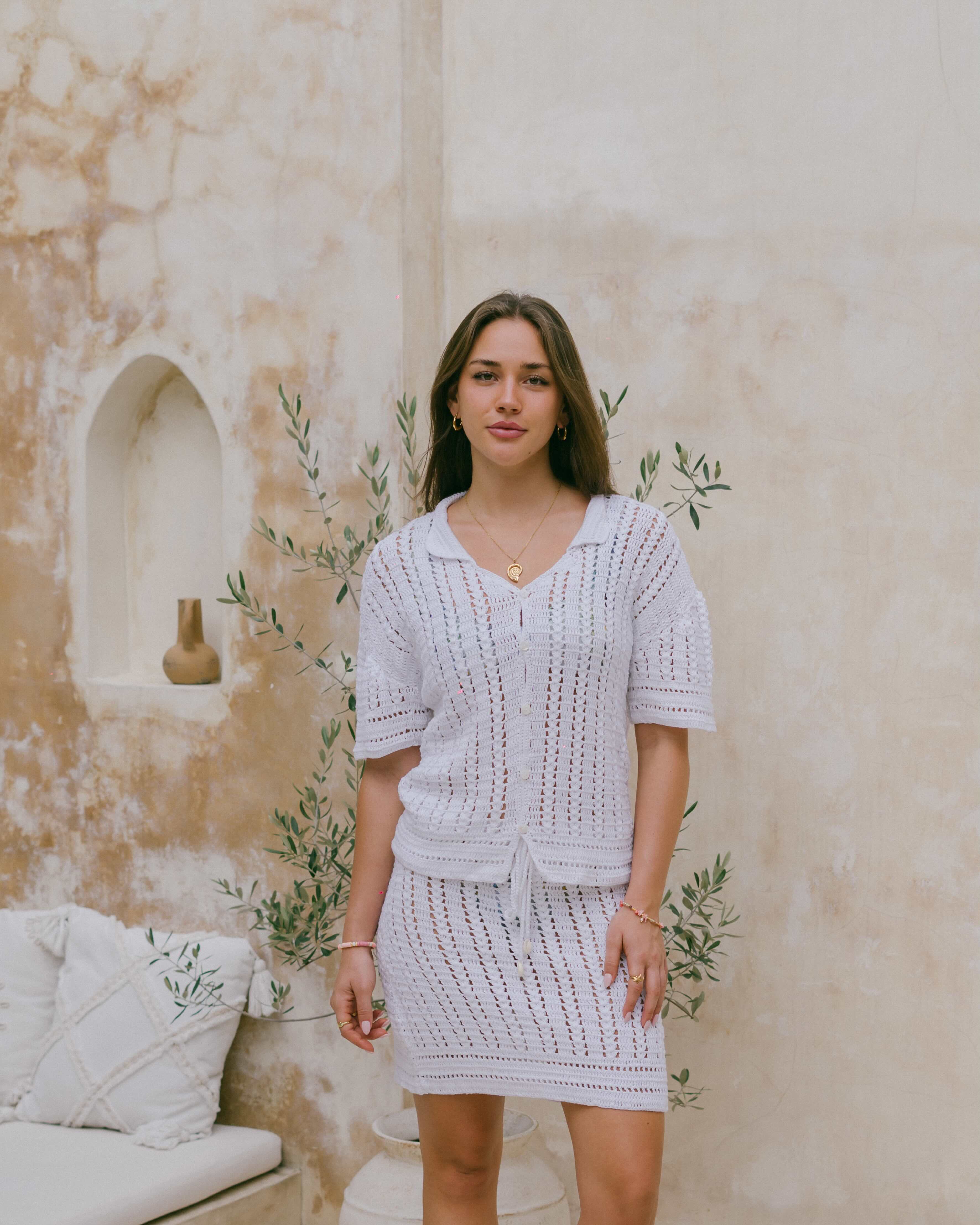The Nalu Crochet Shirt is crafted from 100% cotton with a breathable open-knit, shell buttons, and collared neckline for effortless coastal style.