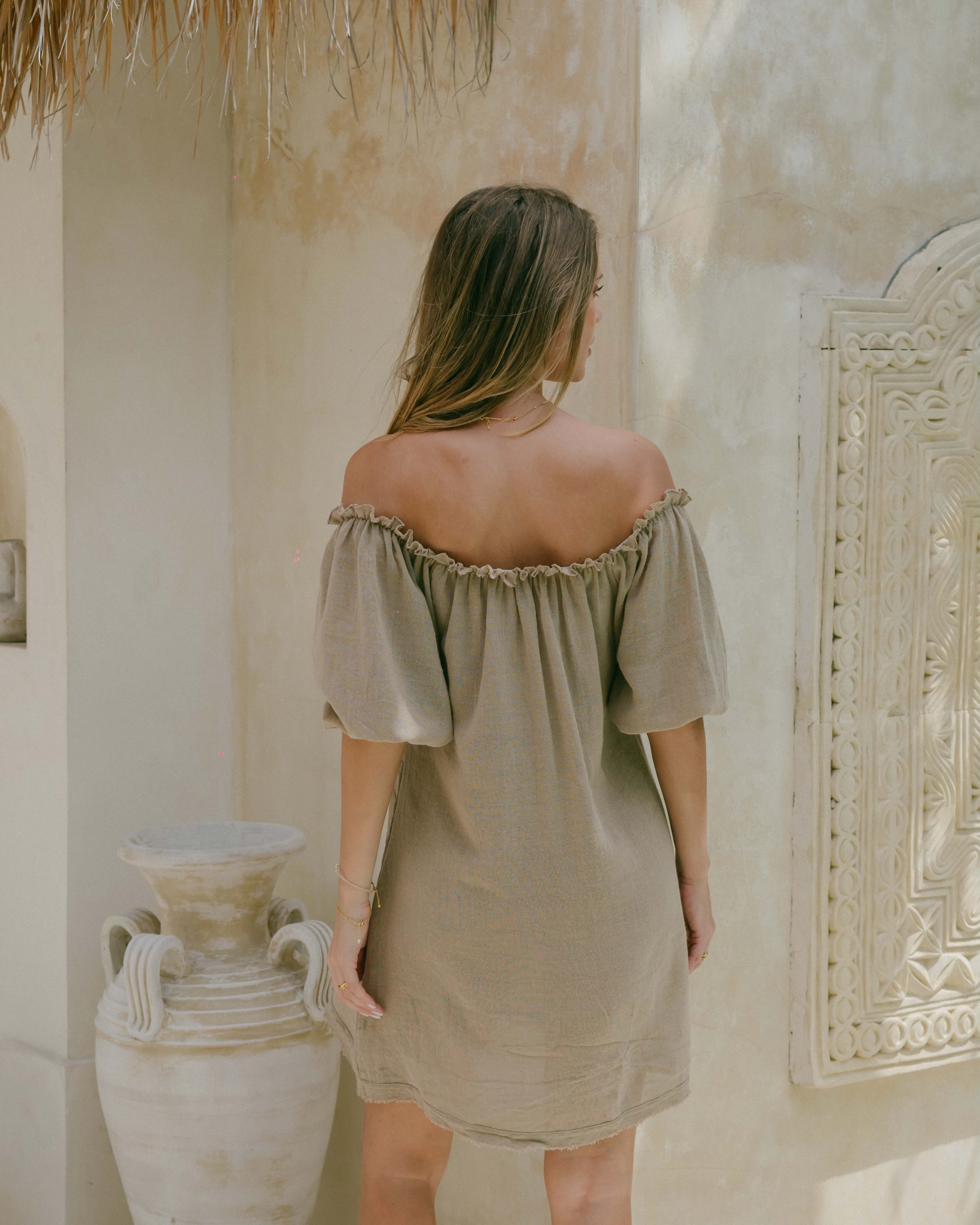 Made from natural ramie, this chic summer mini dress offers puff sleeves, a ruffle trim, and frayed details. Soft, lightweight, and double-lined for easy all-day wear.