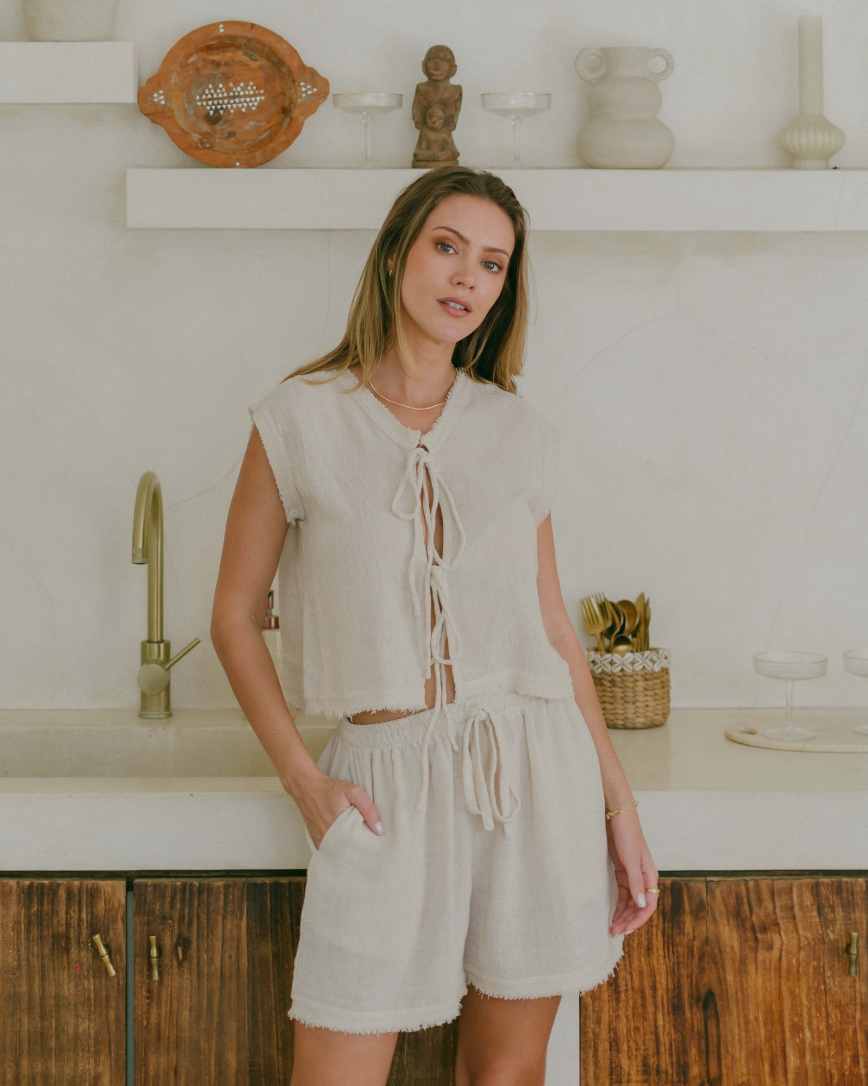 The Romy reversible tank offers effortless style with frayed trim, a boxy silhouette, and versatile design. Wear it tied in front or reversed for a clean neckline.