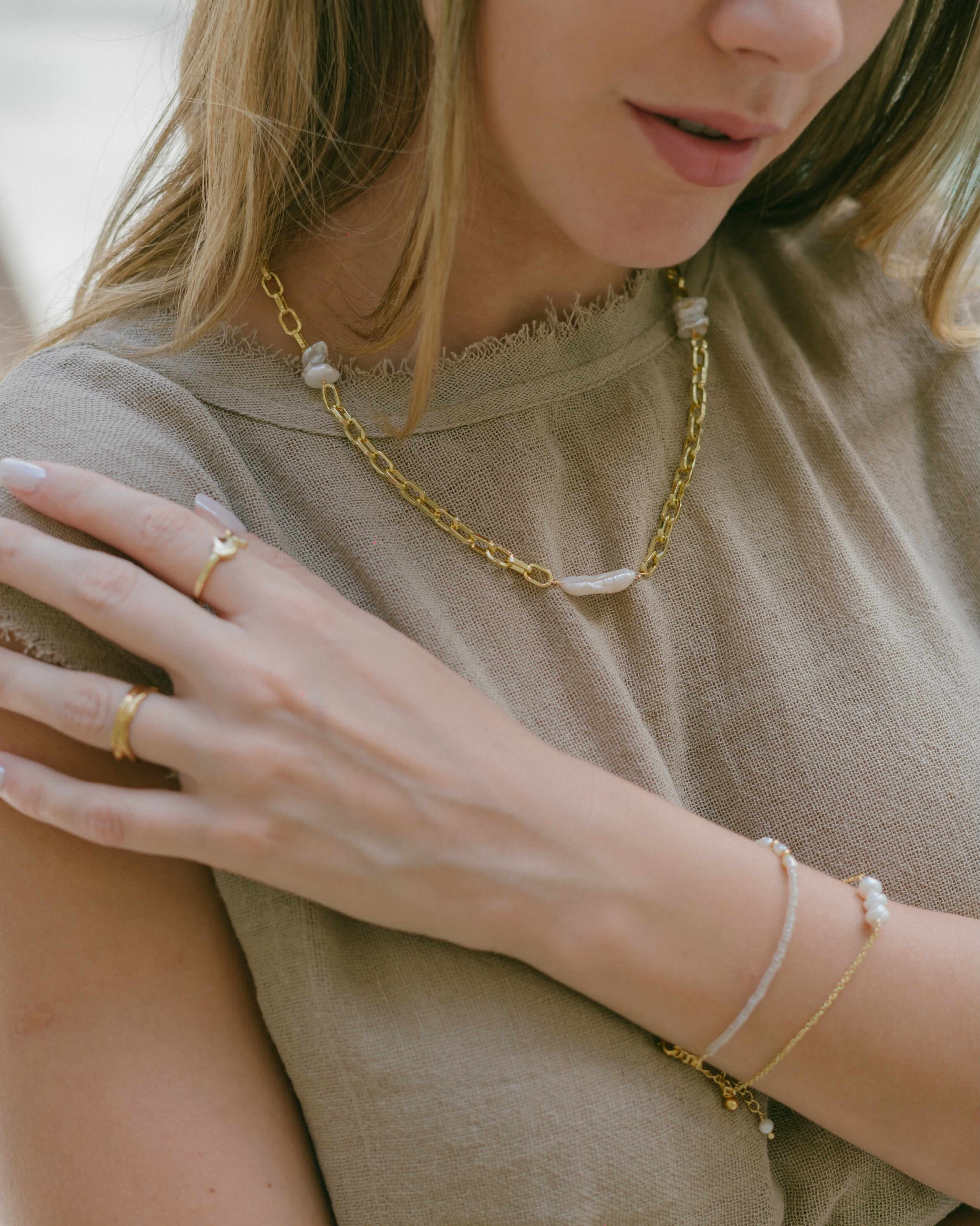 Elevate your jewellery collection with a chunky gold chain necklace featuring three freshwater pearls draped across the links. The Pearl Cascade Necklace combines bold design with classic pearls for versatile wear.