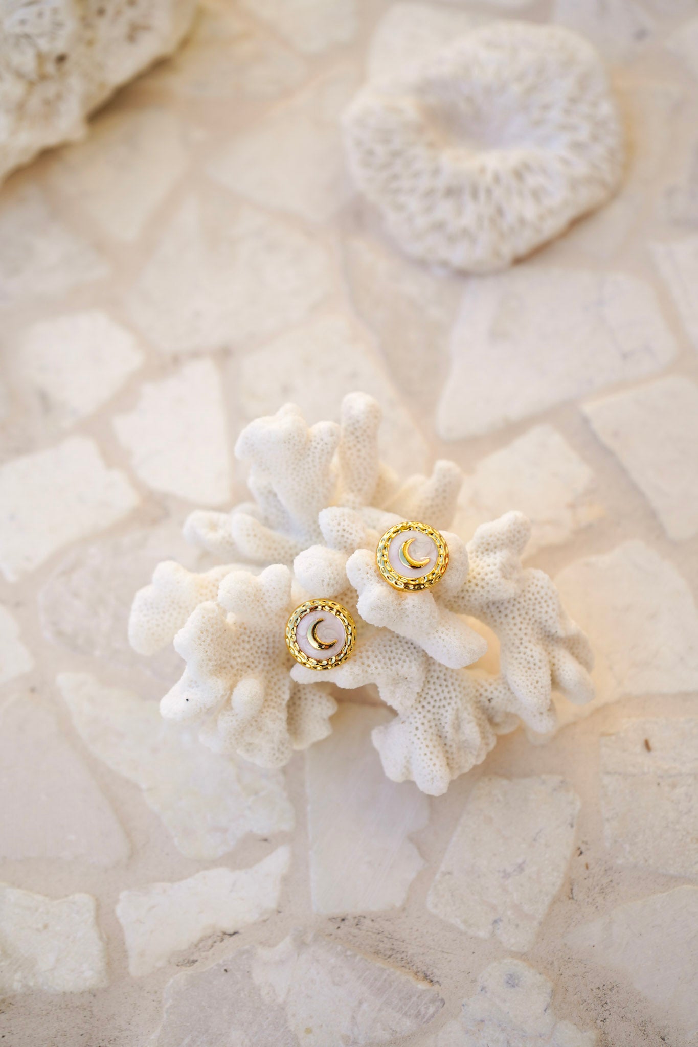 Elevate your style with Elara Stud Earrings featuring glossy shell-like round studs, textured detailing, and a delicate gold moon accent. Lightweight and versatile for any occasion.