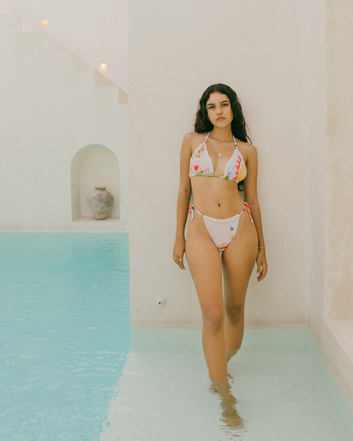 Festive table art print swimwear made in collaboration with artist, Alexandra strong. Crocheted details, triangle tie up and sustainably made from recycled plastics.