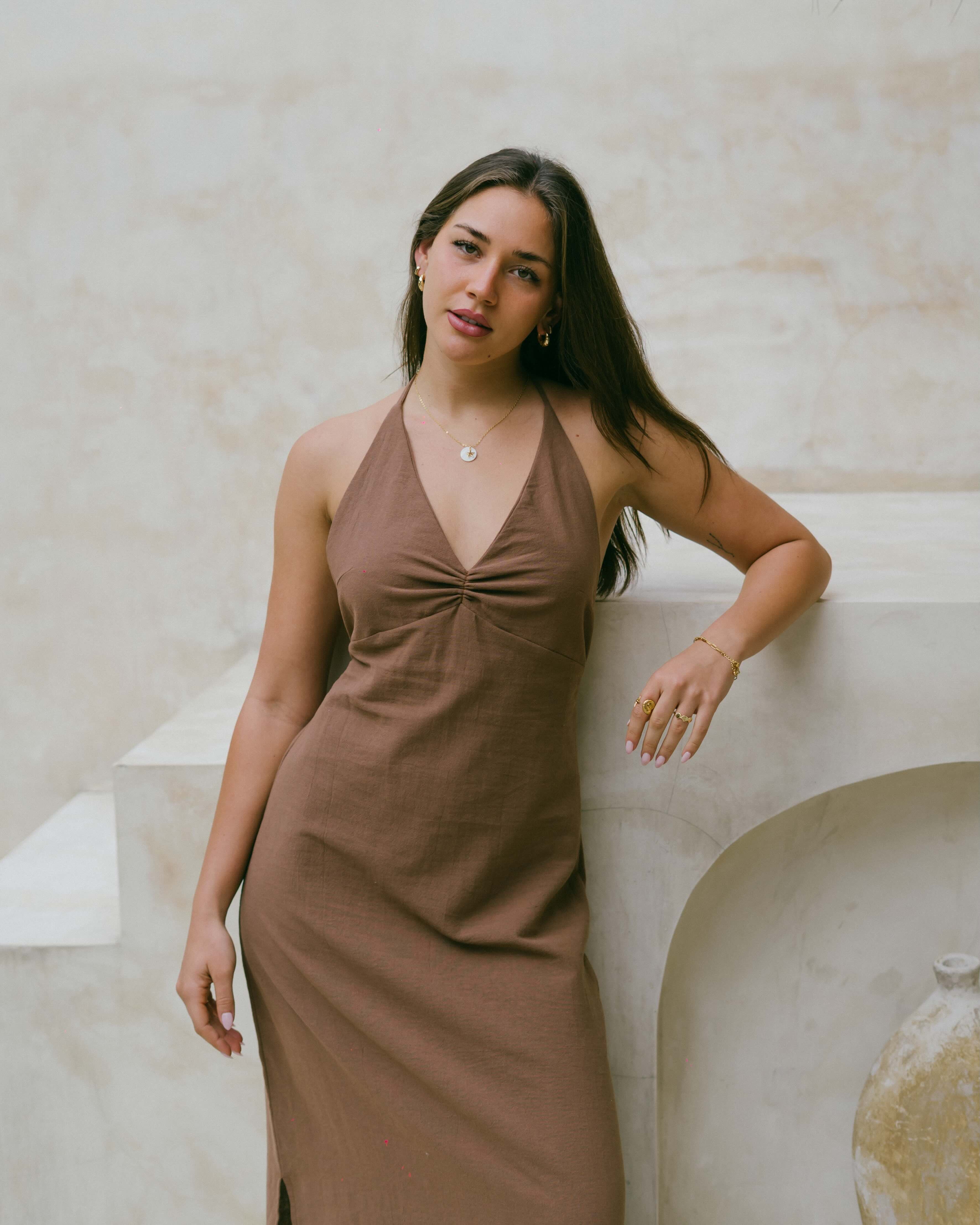 The Palma Maxi is a timeless halter dress with side slits, elasticated back, and soft tie-up neckline — perfect for warm days and balmy nights.