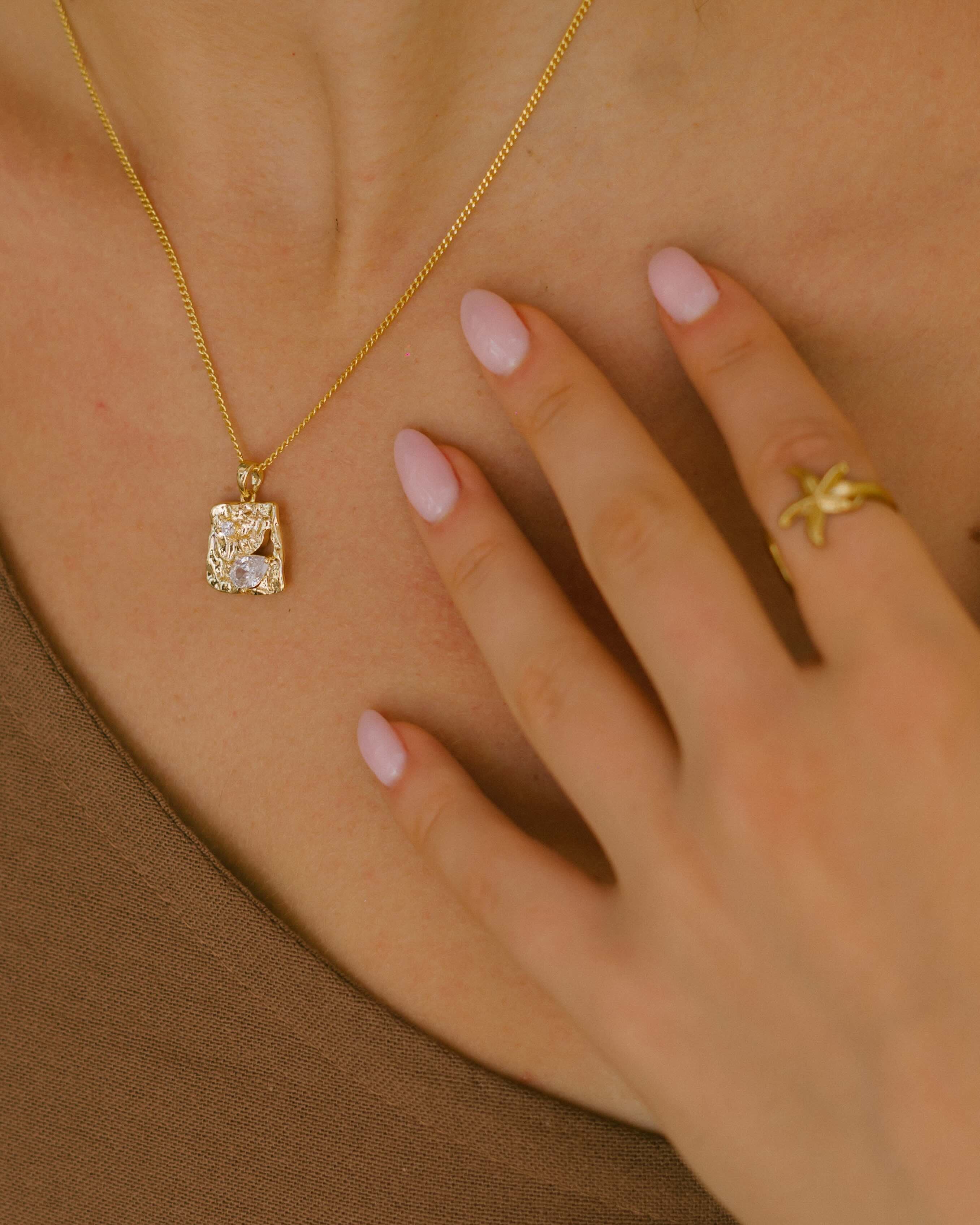 18k gold plated Solea Necklace with white zirconia embedded into hammered square pendant. Malia Jewellery