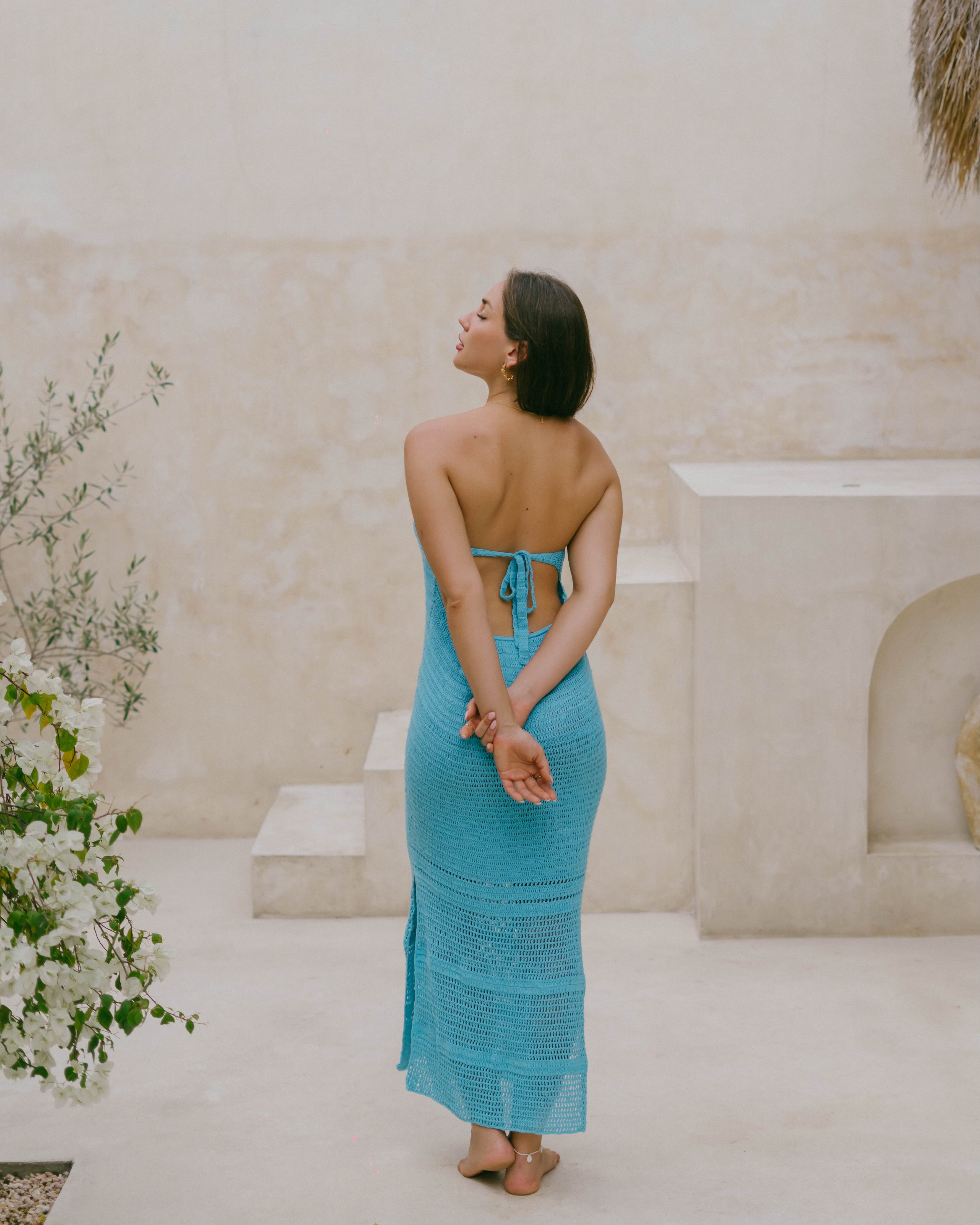 The Azure Crochet Maxi Dress is crafted in teal crochet with an open weave skirt, offering comfort, movement, and timeless summer style.