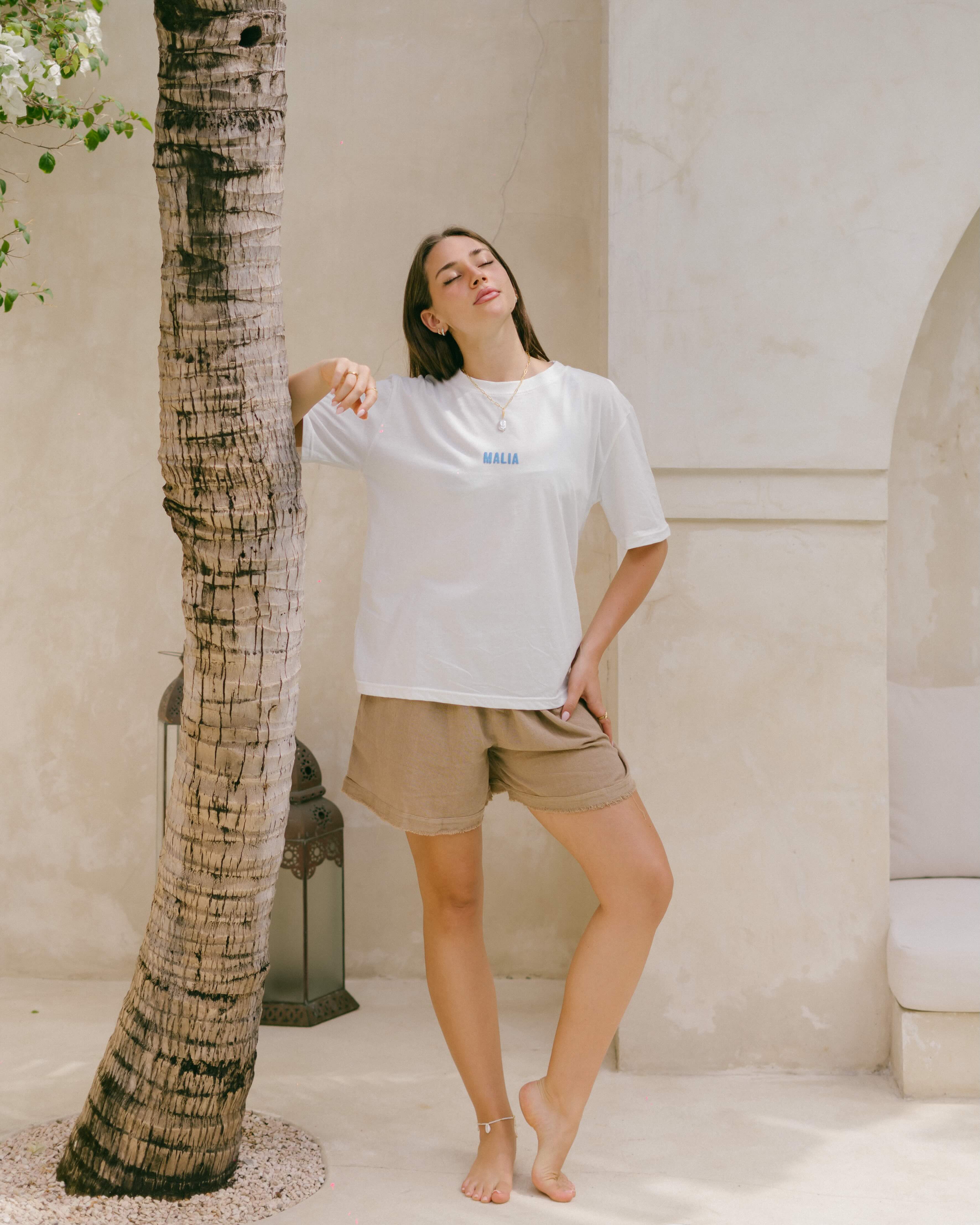 Embrace comfort and intention with this organic cotton oversized tee, complete with ‘Malia’ front detail and a slow-living back motif.