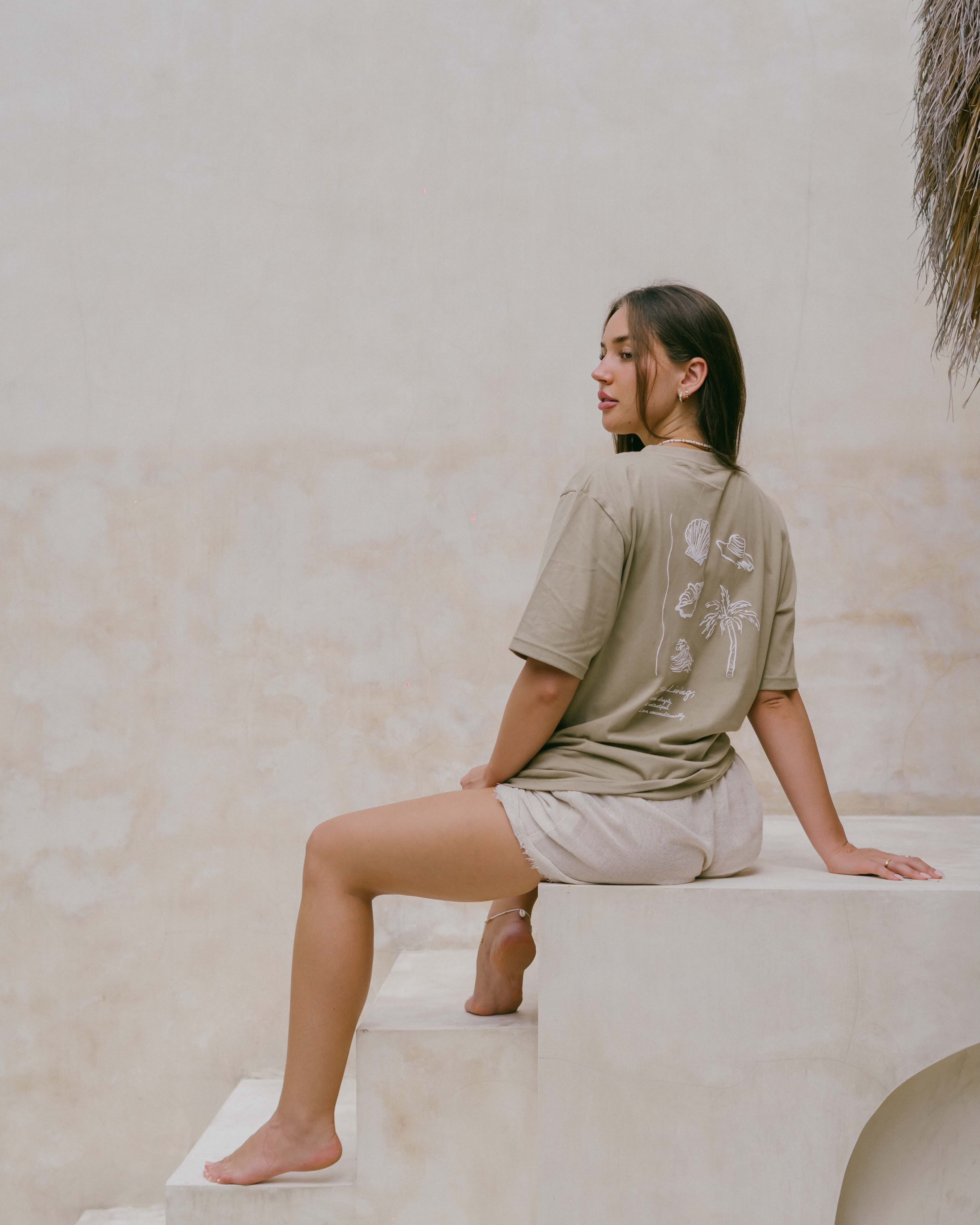 A relaxed, oversized organic cotton t-shirt featuring ‘Malia’ front detail and a coastal-inspired motif to encourage mindful living.