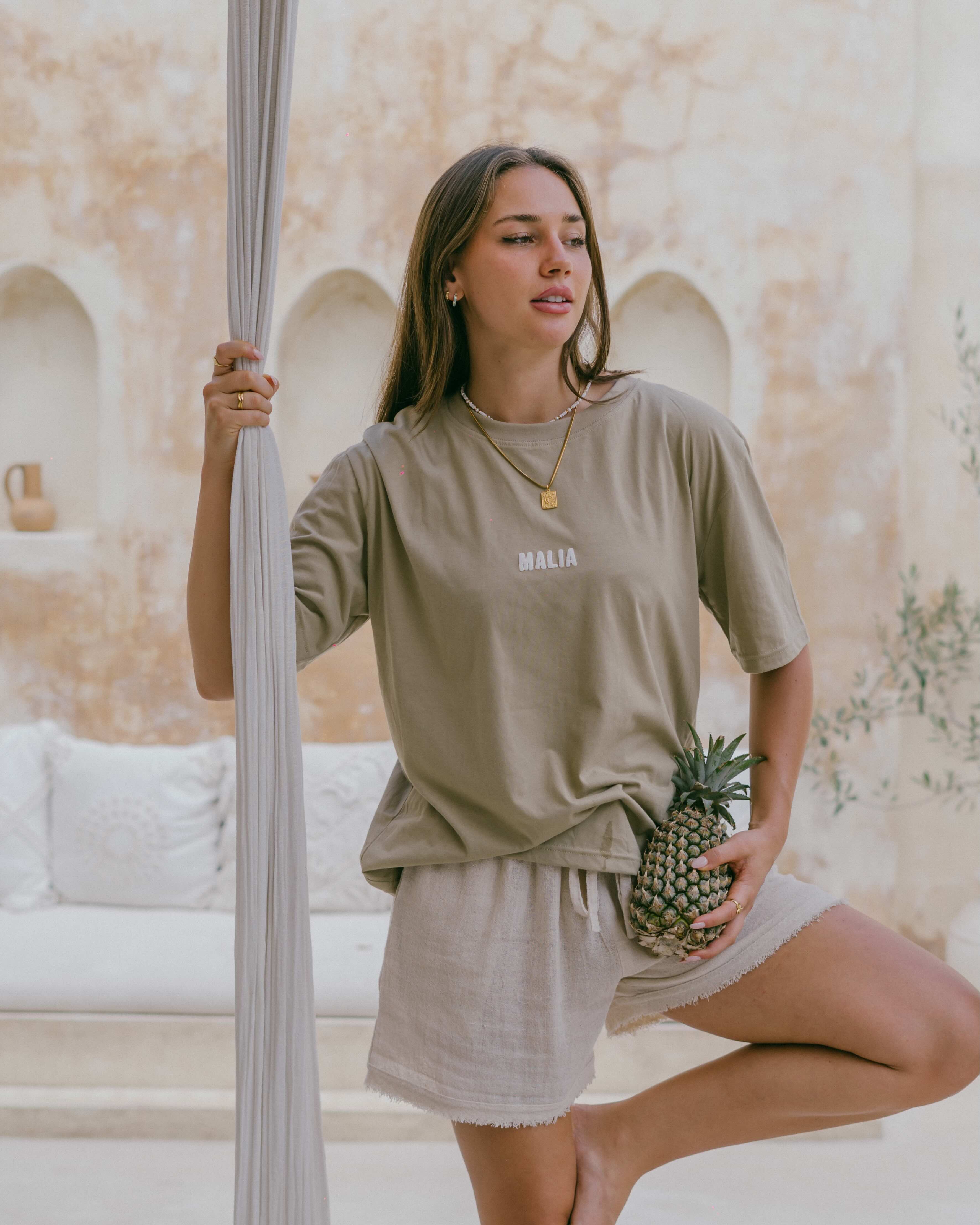 The Malia Organic Cotton Tee blends comfort and sustainability with 100% organic cotton and a mindful slow-living inspired back print.