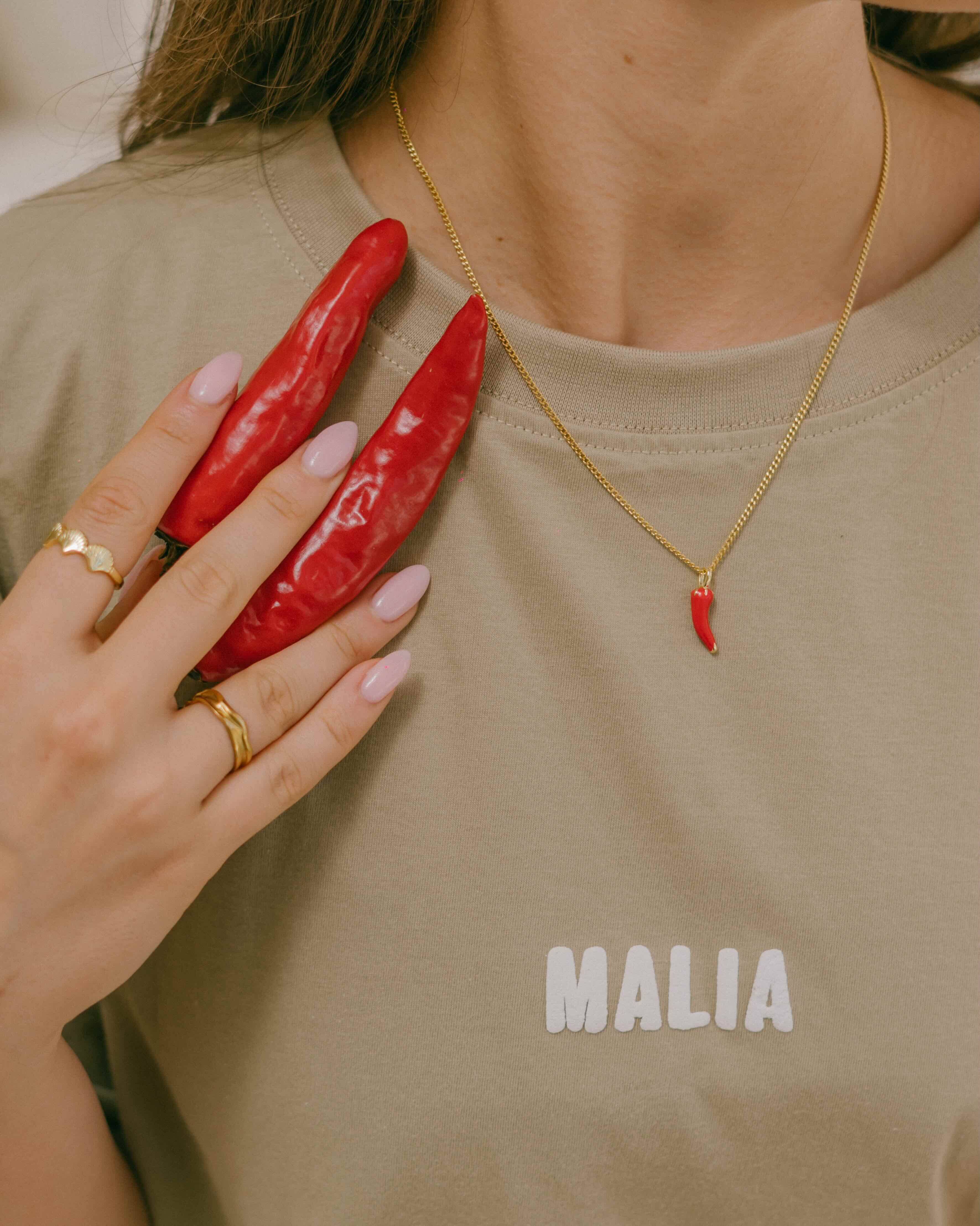 Discover the Caliente Chilli Necklace—chilli pendant with gold drop accents for a fun and fashionable accessory. A versatile piece for day or night wear.