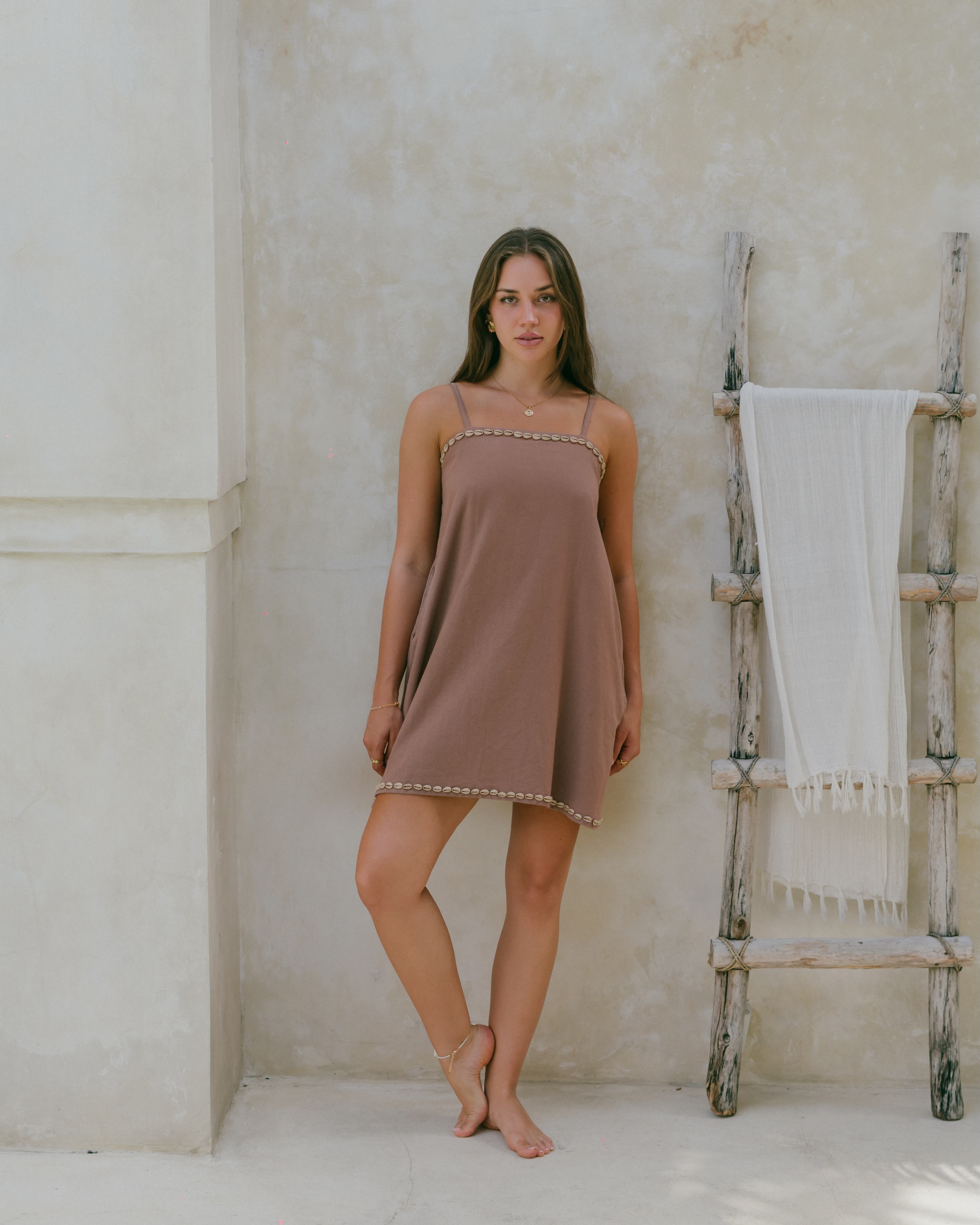 Effortless and breezy, this shell-trimmed mini dress moves with you, with adjustable straps and side pockets for comfort and style.