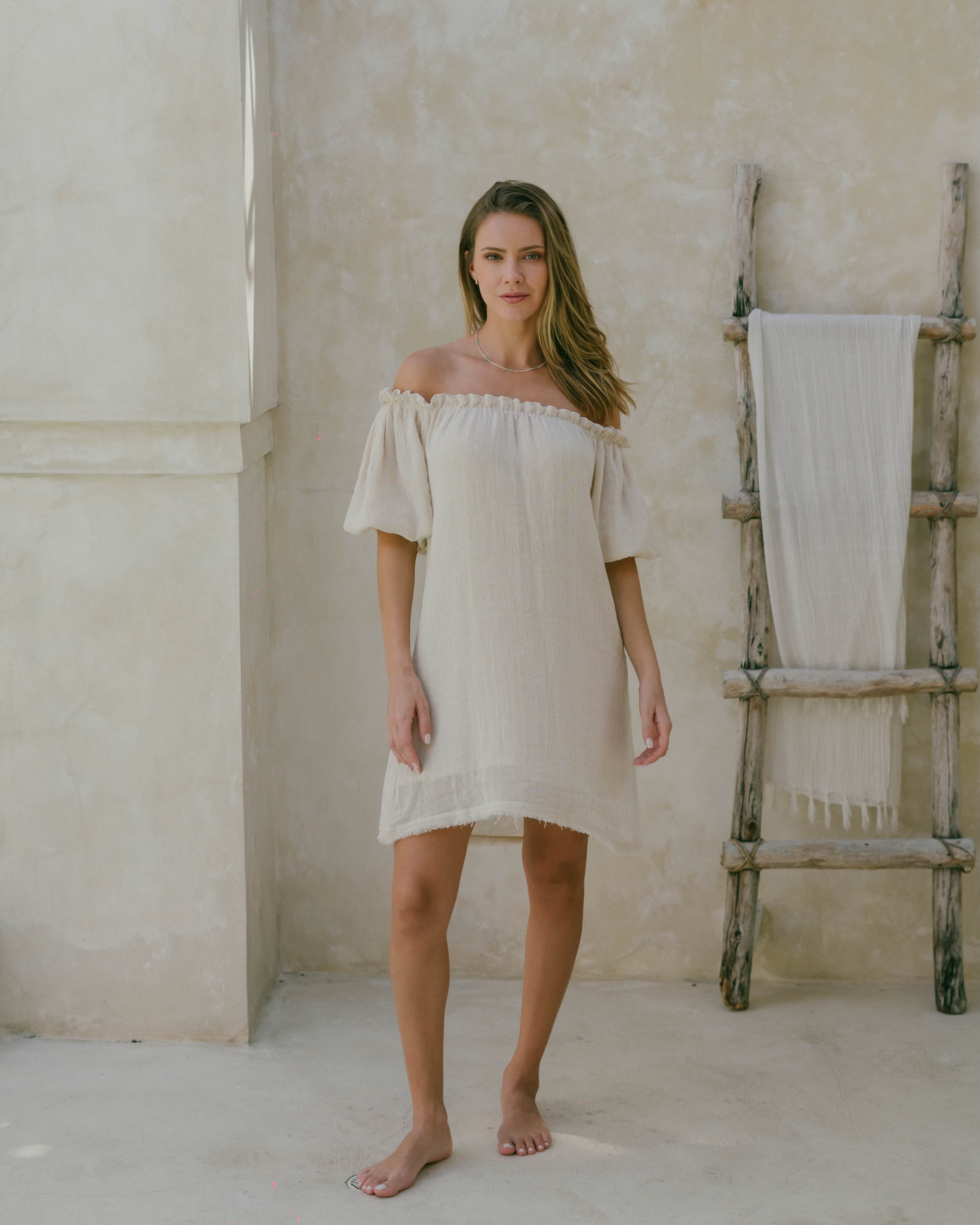 Natural ramie puff sleeve mini dress featuring a ruffle top edge, frayed hem, and breathable double lining—your go-to for effortless summer style.