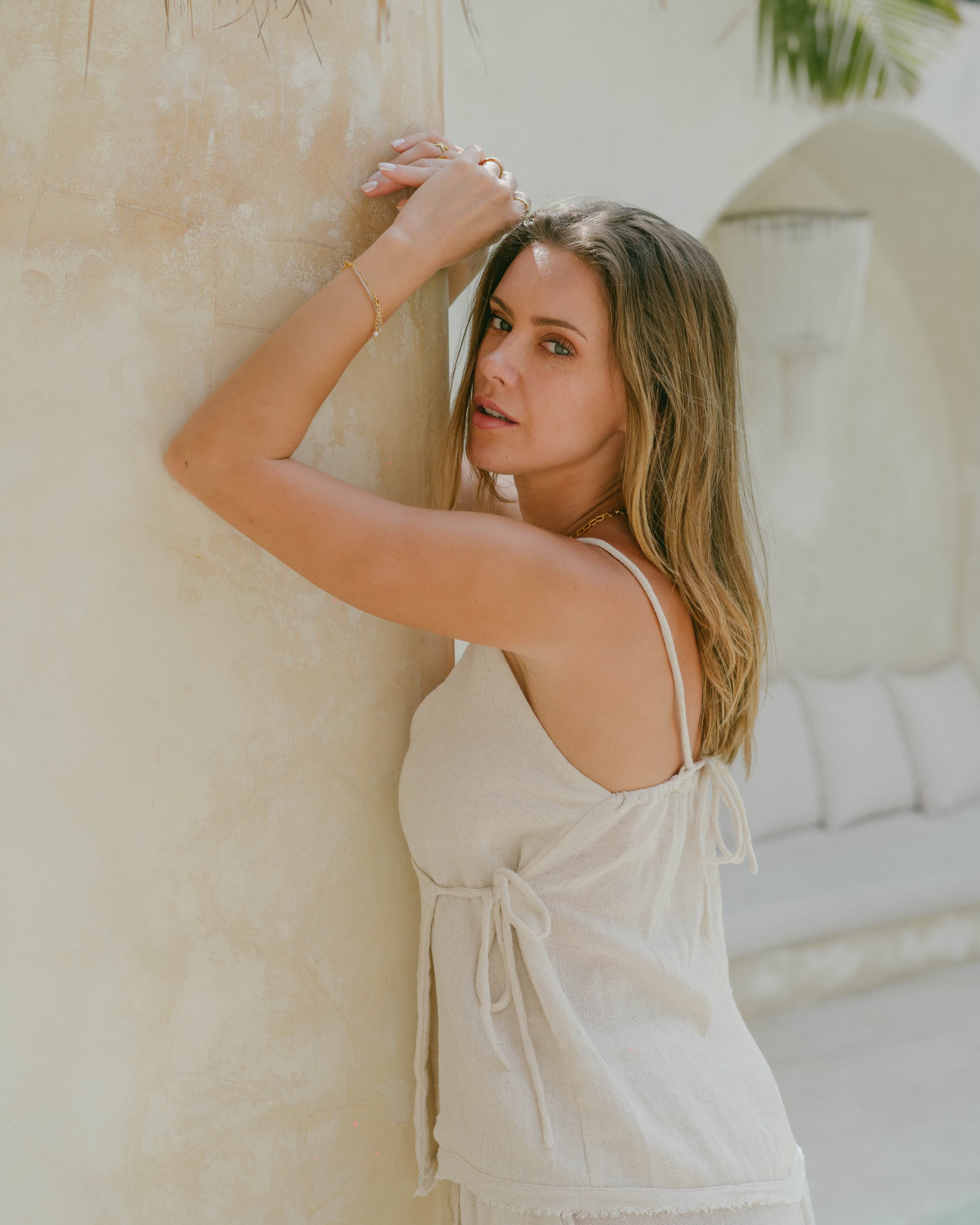 This ramie cotton wrap top is breathable, lightweight, and endlessly versatile. Designed with a V-neckline, tie-up back, and frayed edges for a relaxed yet refined look.