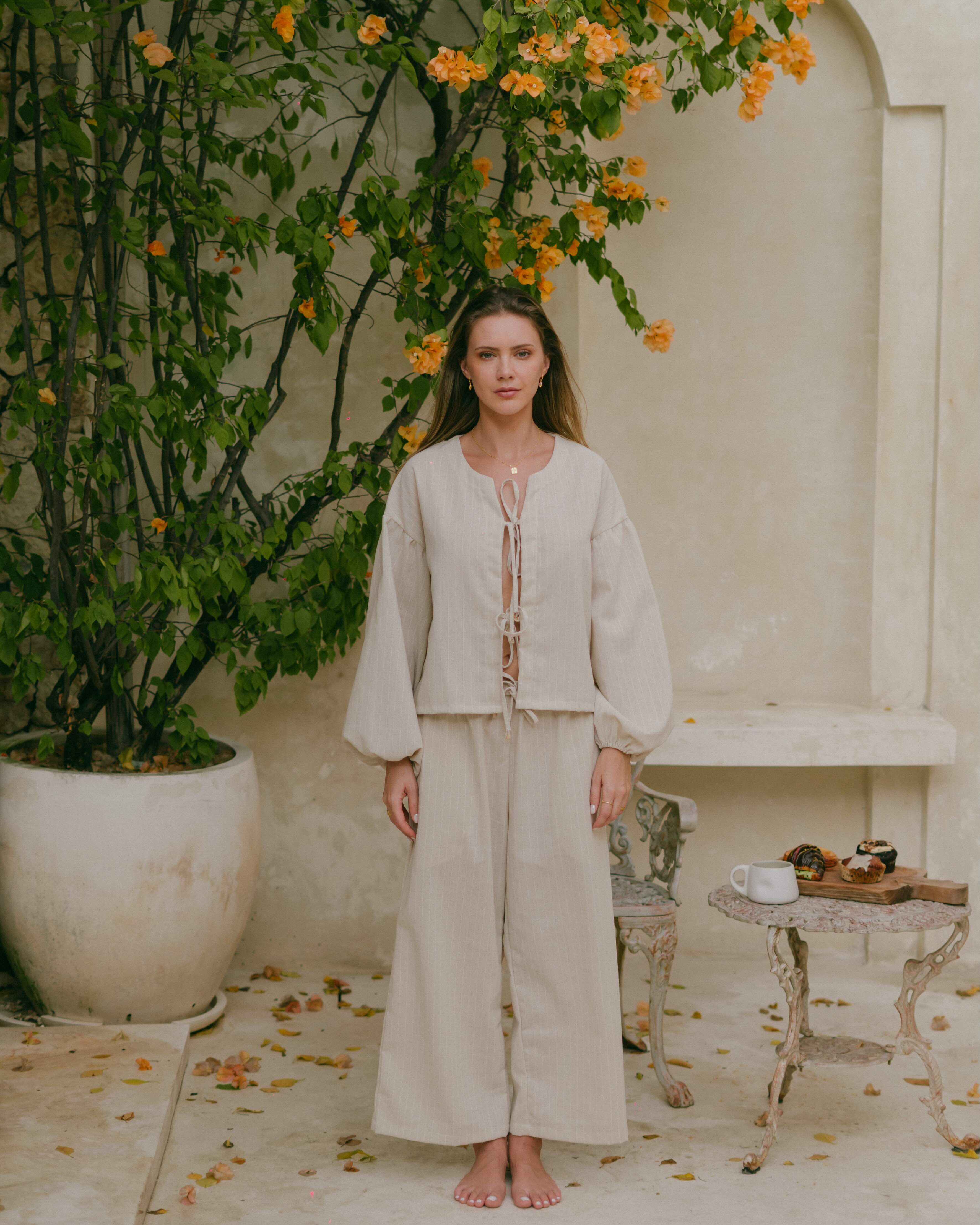 Euro summer–inspired Amalfi blouse with lightweight fabric, front ties, and breezy bishop sleeves.