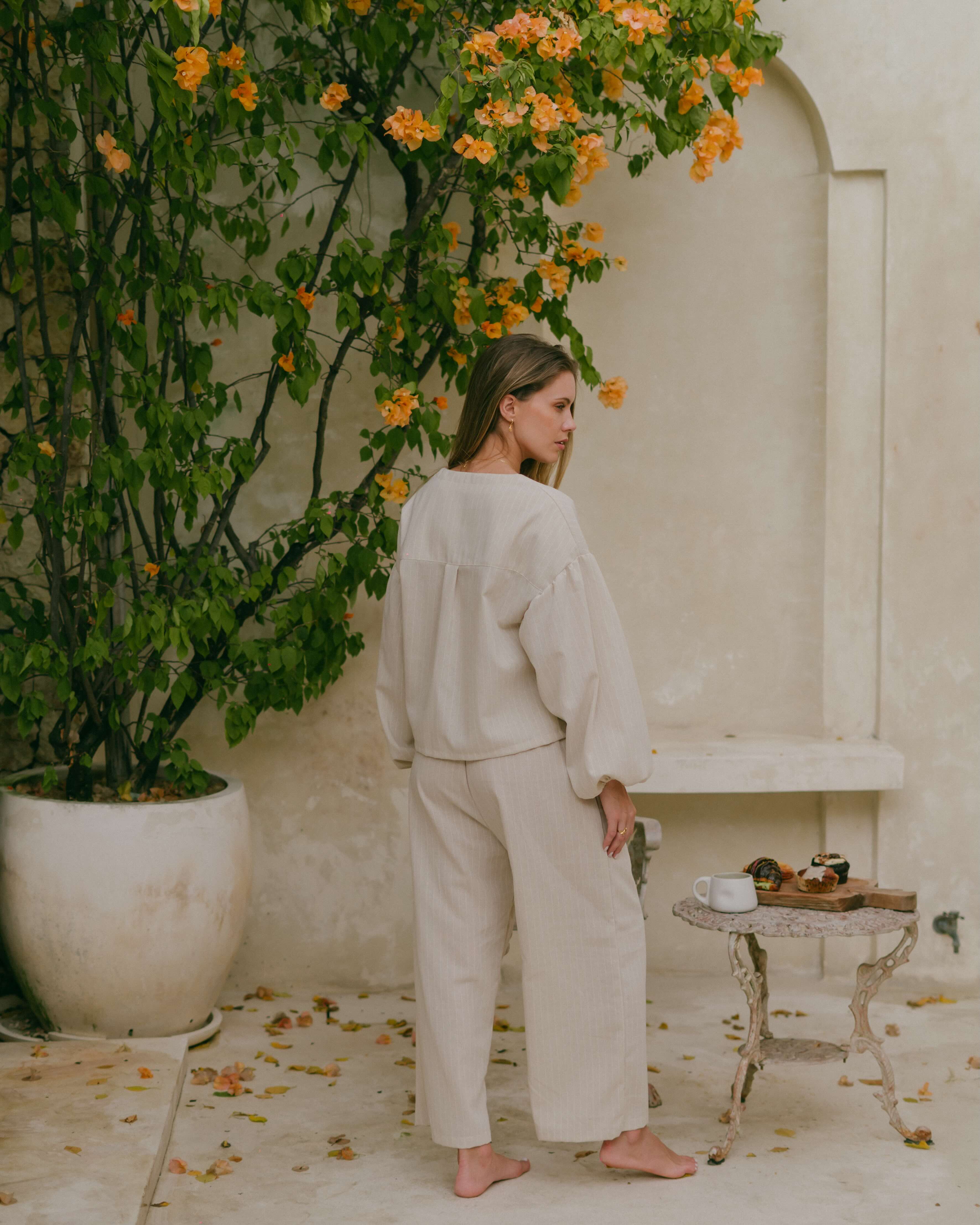 The perfect coastal layering piece – the Amalfi tie-up top with shell accents and relaxed elegance.