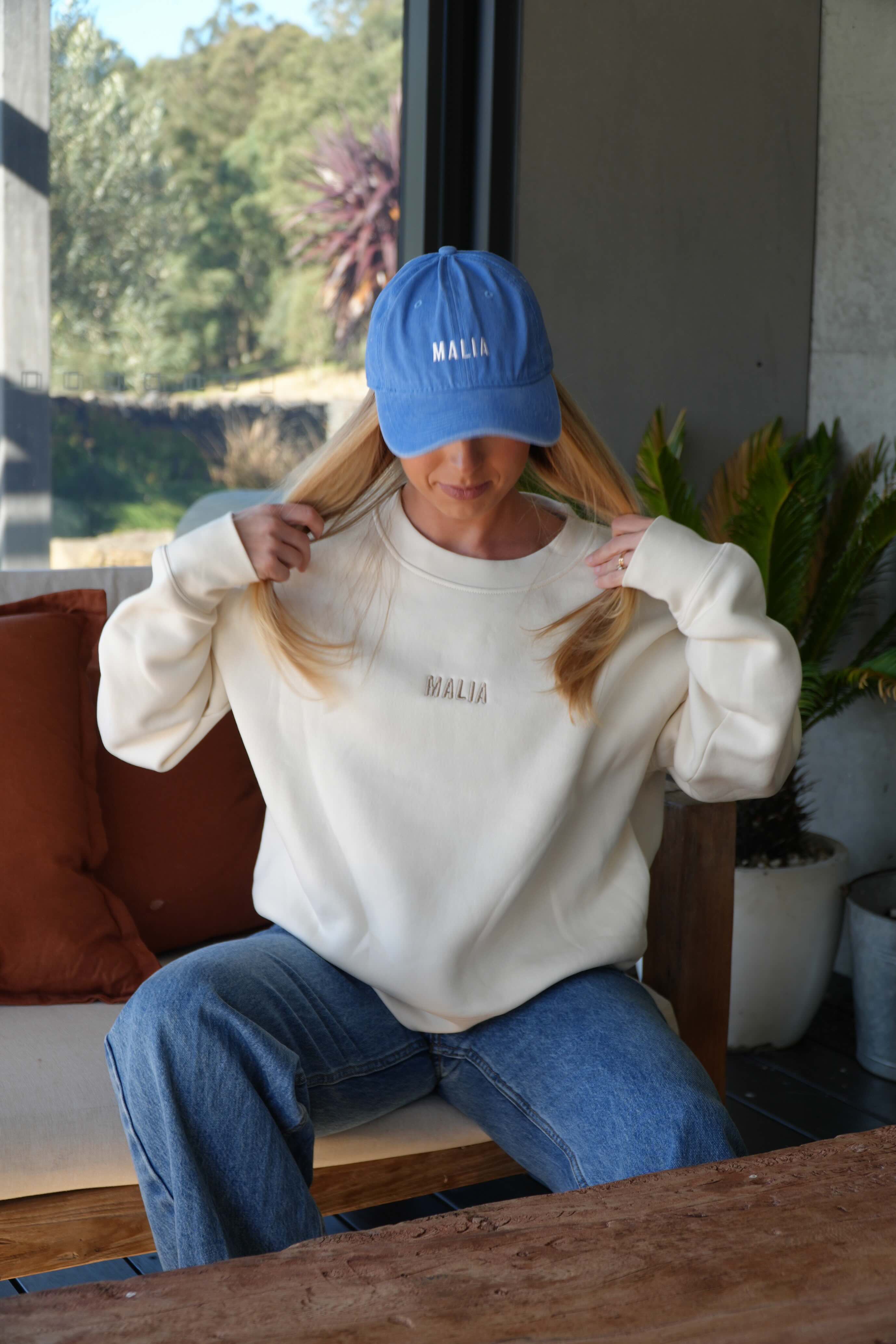 The blue Malia cap with embroidered logo is the perfect accessory for effortless, everyday wear.
