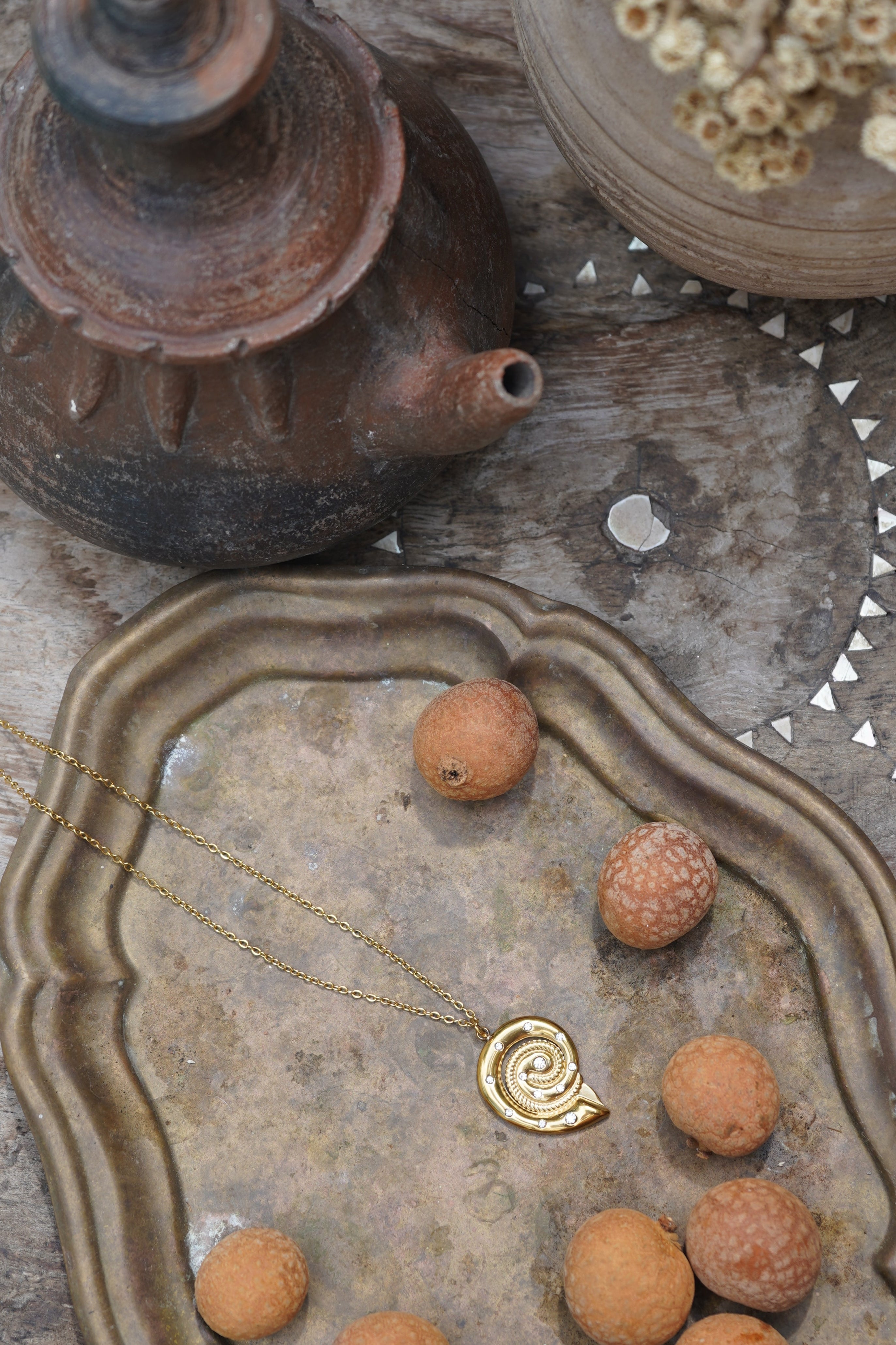 Elevate your look with the Sirena Conch Necklace, featuring a gold chain and statement conch shell pendant accented with diamanté stones. Waterproof and durable for year-round wear.