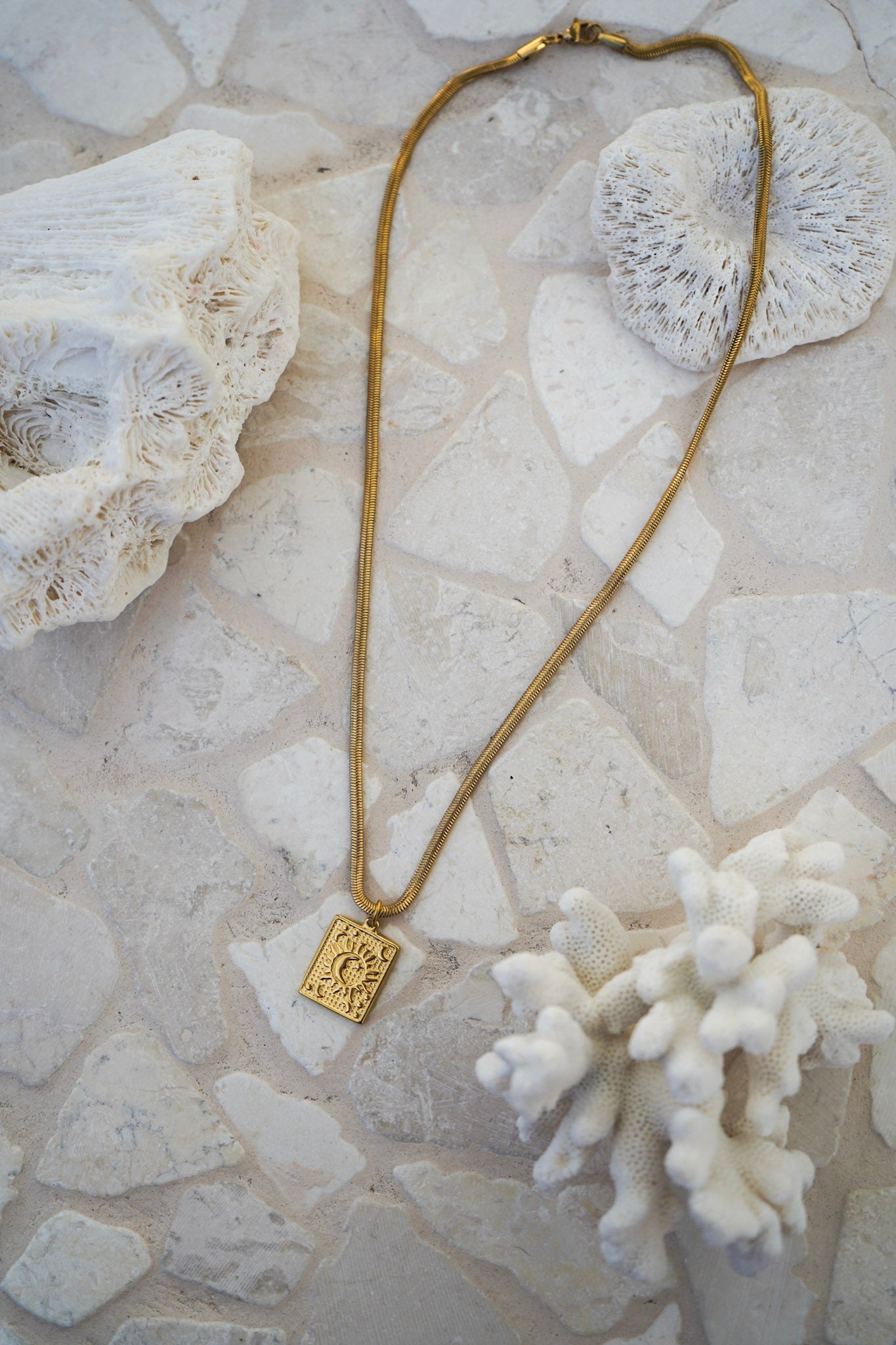 Embrace celestial elegance with our water-resistant snake chain necklace, featuring a square sun and moon pendant. Lightweight, versatile, and perfect for layering, it’s a must-have gold piece for everyday wear.