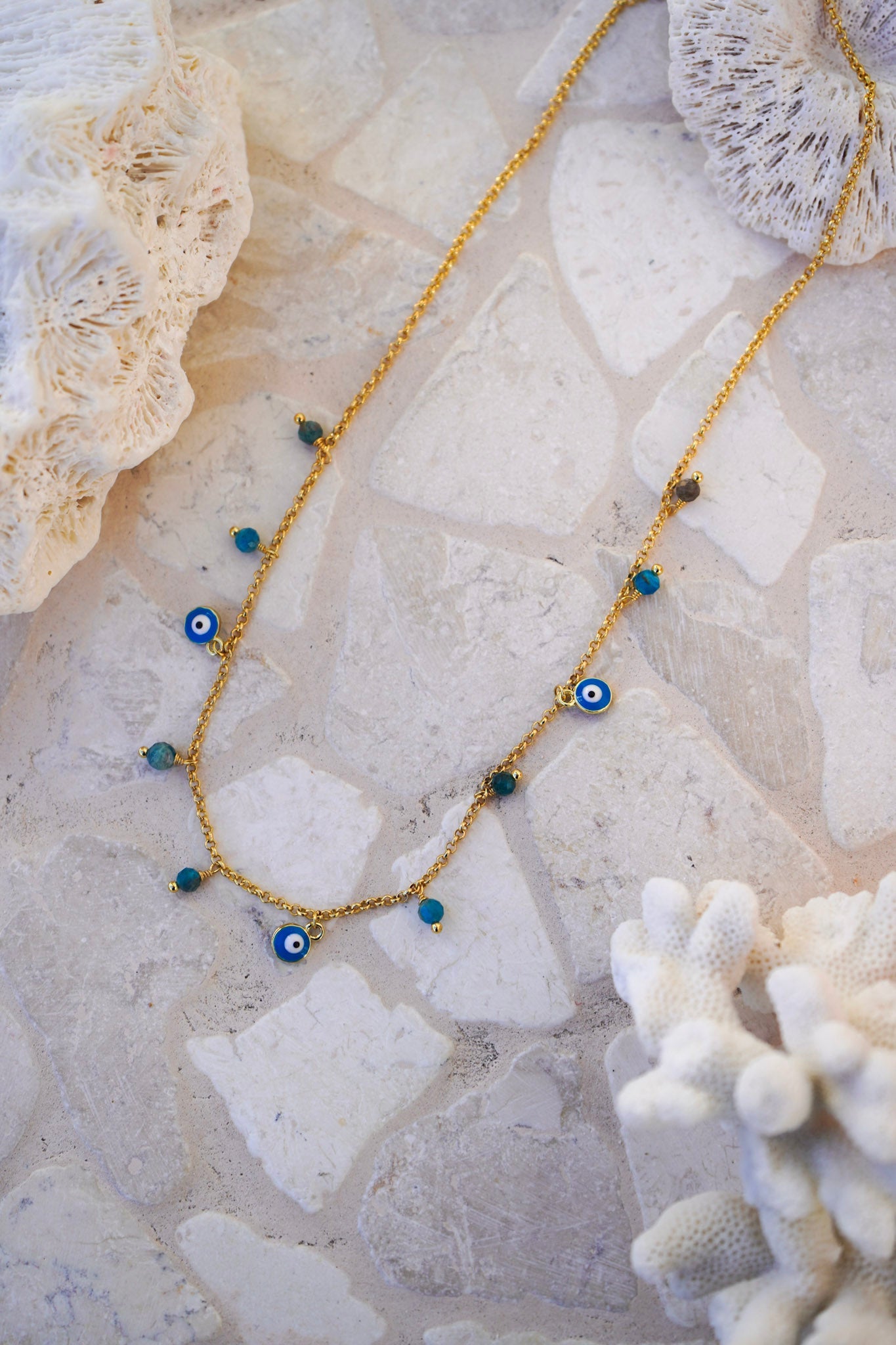 Shop the Talisman necklace, an evil eye and apatite stone detailed charm necklace by Malia the label.