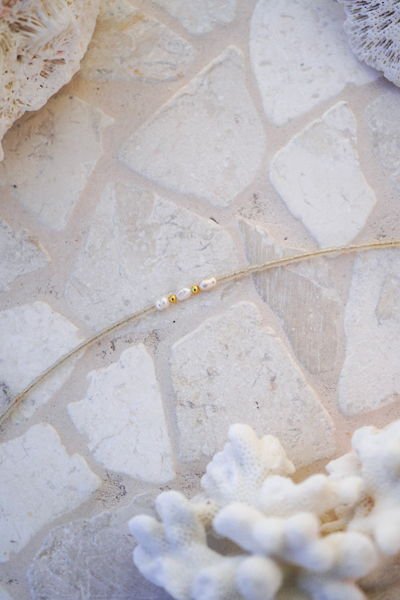 Elevate your jewellery collection with the Shoreline Pearl Necklace, featuring neutral beige beads and three pearls for timeless coastal elegance.