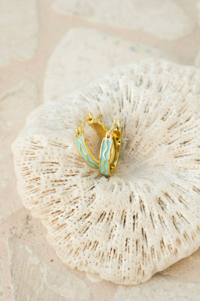 Gold hoop earring with blue accents on a piece of coral - Maris hoops - Malia the label