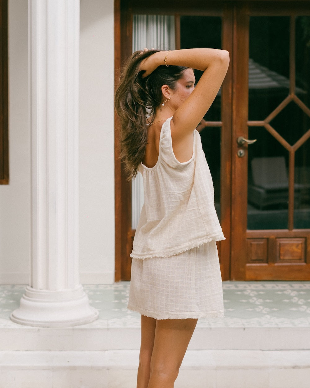 Sofia matching set with singlet top and skirt - model stands holding hair up side on, detailing the checked ramie fabric - Natural fibre clothing by Malia the label