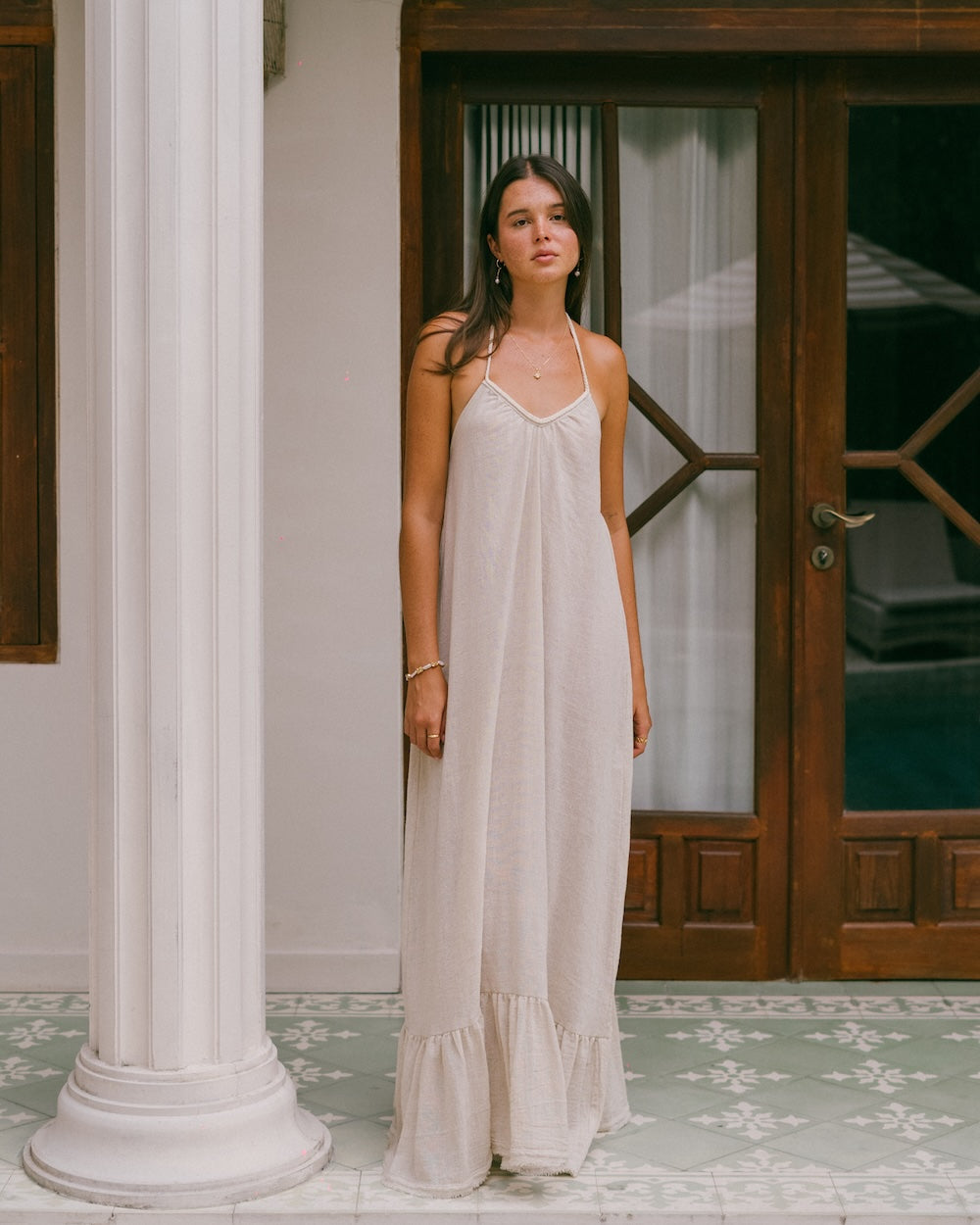 Vela Maxi Dress in natural ramie fabric — full length floor-sweeping silhouette with ruffled hem and convertible braided v-neckline — 80% ramie 20% cotton — Malia The Label — natural fibre maxi dress Australia